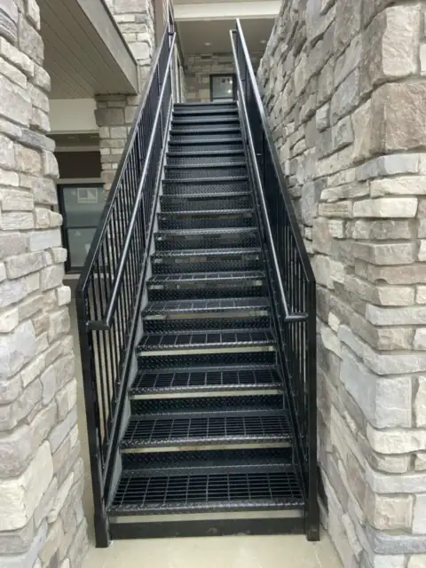 Straight black stairs in tight area